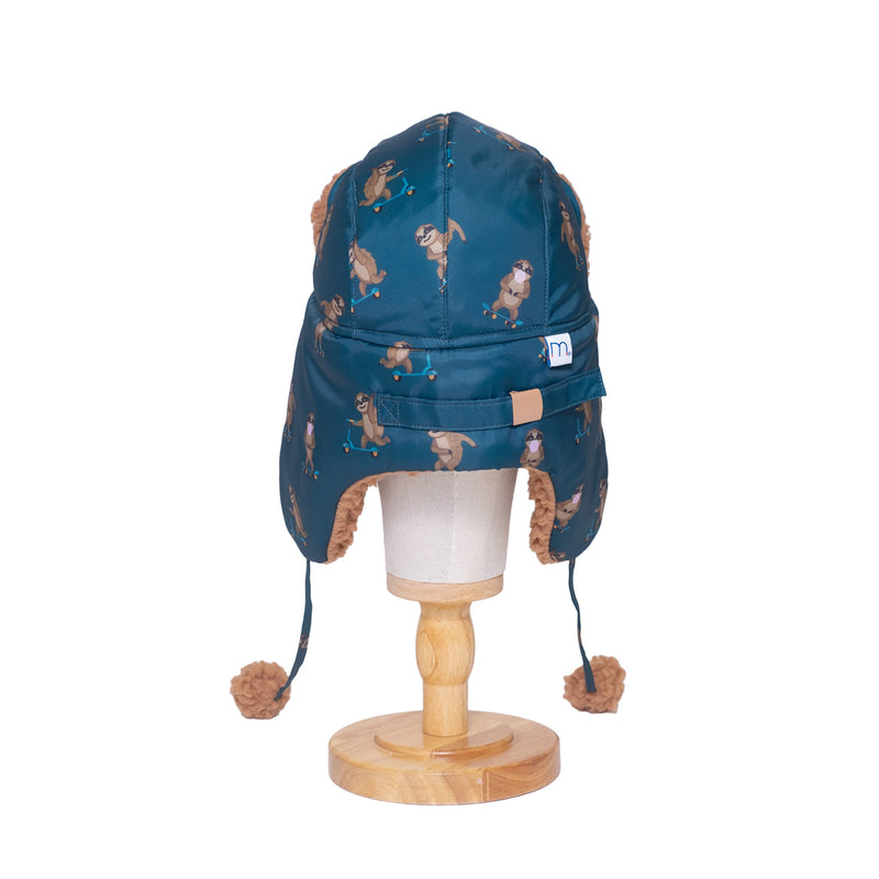 The Cozy Trapper Hat – Skating Sloths Print with Curry Tan Sherpa Liner & Pompoms