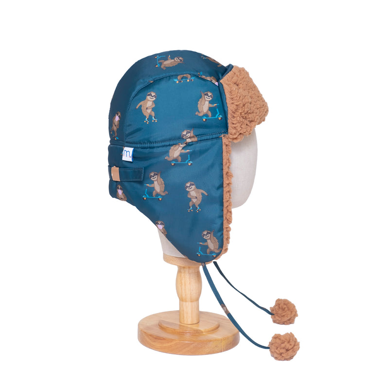 The Cozy Trapper Hat – Skating Sloths Print with Curry Tan Sherpa Liner & Pompoms
